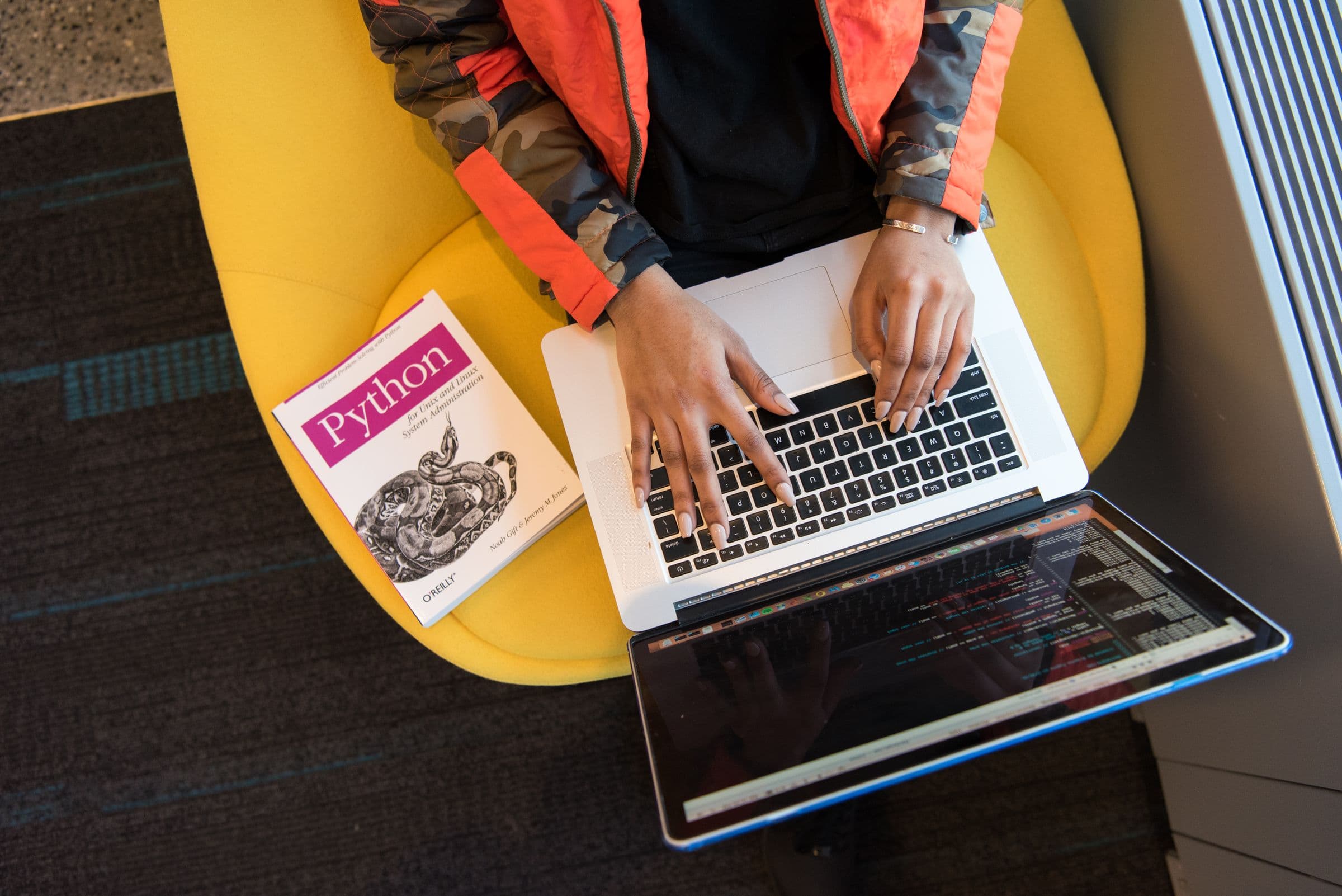 Laptop and design tools on a desk during a website build.